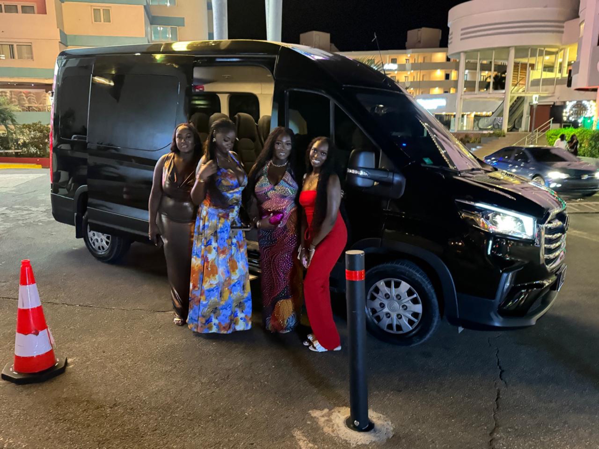 Guests boarding a black Johnson Fantastic Transport van at night in Sint Maarten