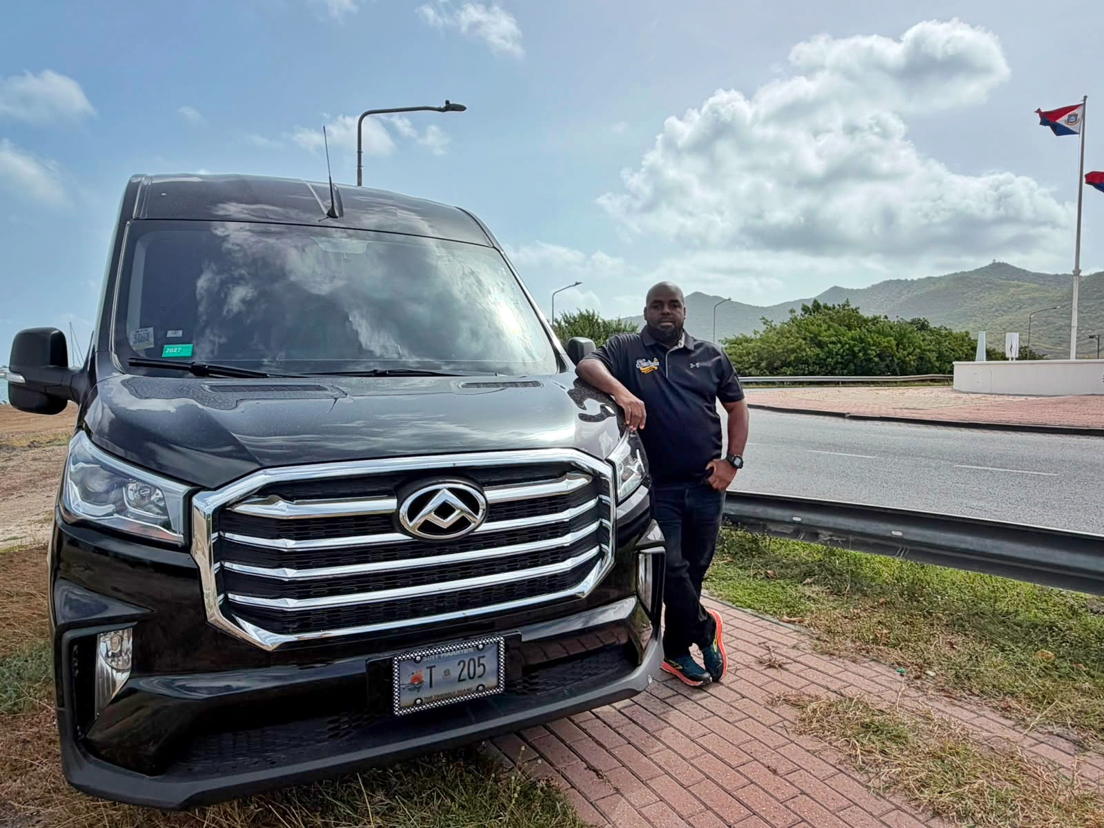 Guests beside a sleek black Johnson Fantastic Transport van for a private SXM airport transfer