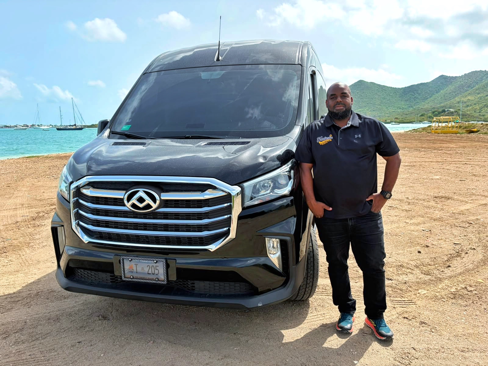 Guests beside a black Johnson Fantastic Transport van for a private SXM airport transfer in Sint Maarten